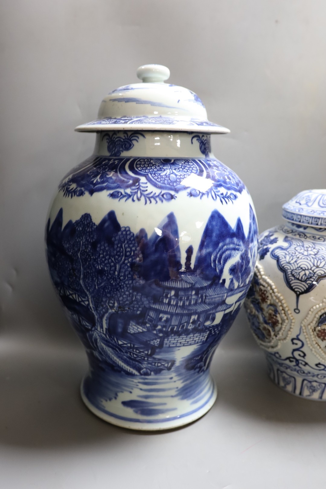 A large Chinese blue and white jar and cover and a blue and white jar and cover, 19th-century and later. Largest 44cm